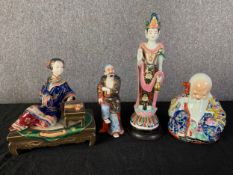 A collection of four Eastern porcelain figures. H.32cm x Dia.9cm. (largest)
