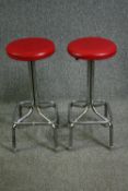 A pair of 1970s tubular chrome bar stools, with red leatherette seats. H.72cm. (each).