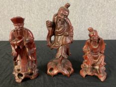 A collection of three Chinese carved hardwood figures. H.19cm x Dia.9cm. (largest)