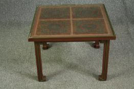 An early 20th century Chinese red lacquered and brass inlaid lamp or coffee table. H.46 W.67 D.67cm.