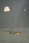 A brass standard lamp with articulated arm along with a floor standing spot lamp. H.140cm. (