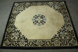 A Chinese woollen carpet with central medallion on an ivory field within a foliate border. L.168 W.
