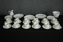 An early 20th century part porcelain tea set for twelve settings. Dia.23cm. (largest).