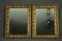 A pair of carved giltwood wall mirrors. H.65 W.48cm. (each).