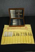 A 19th century cased cutlery set with mother of pearl handles and another similar set of cutlery.