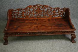 Hall seat, Eastern hardwood, profusely carved. H.54 W.121 D.50cm.
