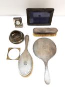 A silver dressing table set along with other items including, a silver desk clock and a silver