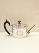 A Georgian silver teapot by John Denzilow, of oval serpentine shaped form with bright cut floral and