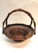 A Meji period Japanese Ikebana bamboo handwoven basket with double strand handle. Signed to base.