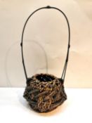 A Meji period Japanese Ikebana bamboo handwoven basket with elongated removable handle. Signed to