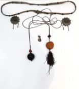 A collection of oriental items, a carved walnut netsuke, a carved black and red lacquer bead with