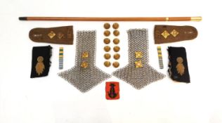 A collection of military items, including a pair of chain mail epaulets with British Royal army