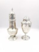 An Edwardian silver sugar sifter with flame finial and pierced lid along with an urn form silver