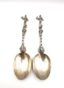 A pair of 18th century Dutch white metal birth spoons, the finial of each of the handles in the form