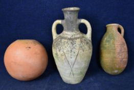 A painted terracotta twin handled urn, a large jug and a vase. Largest H.63cm
