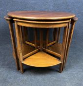 A mid century mahogany nest of occasional tables. H.56 D.60cm (Repairs to undertiers as shown).