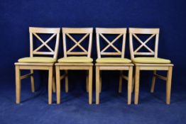 A set of four Continental style light oak dining chairs.
