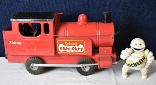 A vintage Tri-ang Puff Puff toy train and a cast iron Michelin man. Train H.23 W.45cm