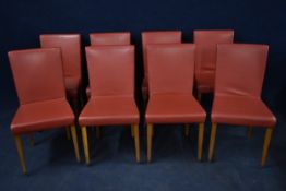 A set of eight contemporary leather upholstered dining chairs.