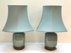 A pair of Chinese style crackle glazed celadon table lamps on hardwood bases. H.76cm.