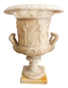 An 18/19th century carved marble twin handled urn in the Medici style with figural relief figures
