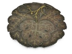 A 19th century Indo-Persian bronze leaf shaped dish with brass inlay. Dia.23cm.