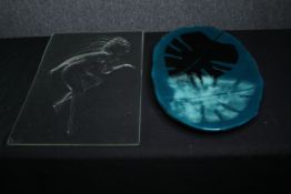 A glass panel with figural decoration in relief along with an art glass plate. L.58 W.35cm. (
