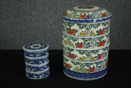 A four tier Japanese porcelain bento box along with a smaller example. Dia.18.5cm. (largest).