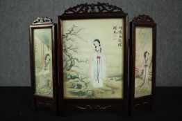 A miniature Japanese screen, hand painted and signed to both sides in a carved hardwood frame. H.