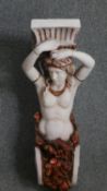 A painted wall planter or sconce in the form of a caryatid. H.76cm.