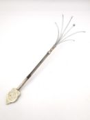 A Chinese silver extending champagne swizzle stick by Wai Kee Jewellers. Hong Kong, one side with