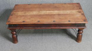 An Indian teak coffee table. H.41 W.108 D.60cm.