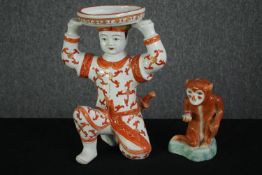 A Chinese porcelain figure of a kneeling warrior and a Chinese seated monkey figure. H.31cm. (