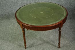A 19th century style mahogany coffee table with inset tooled leather top. H.45 Dia.73cm.