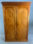 Wardrobe, 19th century mahogany with arched panel doors enclosing a fitted interior. H.201 W.131 D.