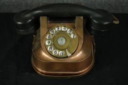 A copper and bakelite reproduction of a vintage telephone. H.14 W.24 D.14cm.