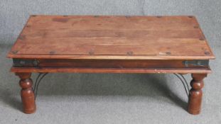An Indian teak coffee table. H.41 W.110 D.60cm.