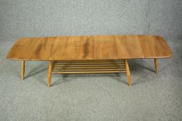 A mid century Ercol coffee table, model 456 in elm and beech. H.36 W.158 (ext) D.46cm.