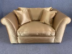 A contemporary loveseat in piped pale bronze satin upholstery. H.77 W.148 D.97cm.