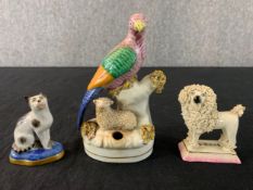 A collection of three 19th and early 20th century Staffordshire animal figures. H.14cm (largest)