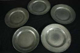 A set of four 19th century pewter chargers, marked and inscribed to the reverse along with a similar