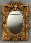 A 19th century style gilt and gesso wall mirror. H.149 W.101cm