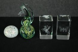 A collection of four glass paperweights. H.14cm. (largest).