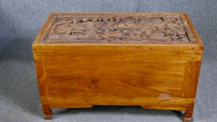 A carved Eastern hardwood coffer. H.61 W.107 D.56cm.
