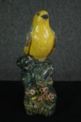 A 20th century Chinese figure of a finch perched on a rock. Artists seal mark to base. H.31cm.