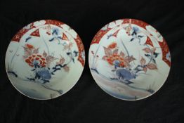 A pair of Japanese hand decorated plates, probably 19th century. Dia.23cm. (each).
