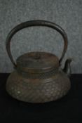 A Japanese cast iron swing handled teapot or kettle. H.22 W.21 D.21cm.