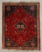 An Abadeh rug with central medallion on a burgundy ground within stylised spandrels and borders. L.