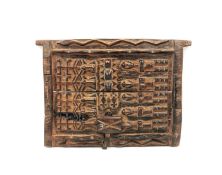 A West African Dogon carved hardwood granary door from Mali, with two allover carved panels