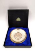 A boxed silver Britannia standard dish commemorating the tri-centennial, 1672-1972, with a central